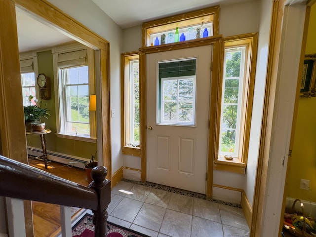 tiled foyer with a baseboard heating unit