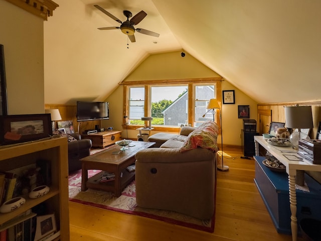 living room featuring vaulted ceiling, ceiling fan, and light wood-type flooring