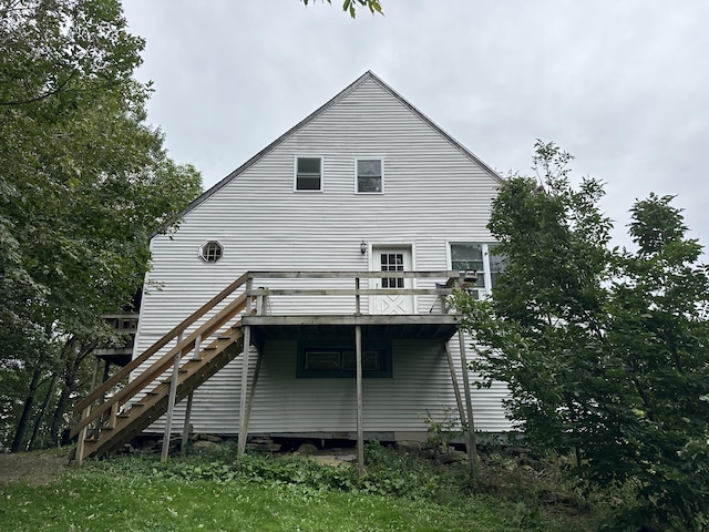 back of property featuring a wooden deck