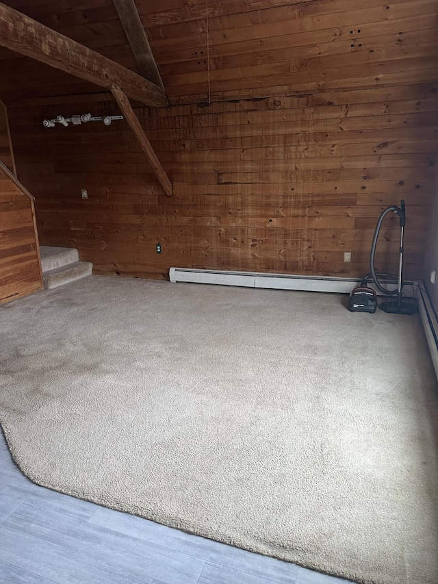 spare room with wooden ceiling, hardwood / wood-style floors, vaulted ceiling with beams, and wooden walls