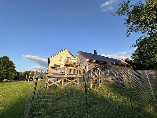 back of house featuring a yard and a deck