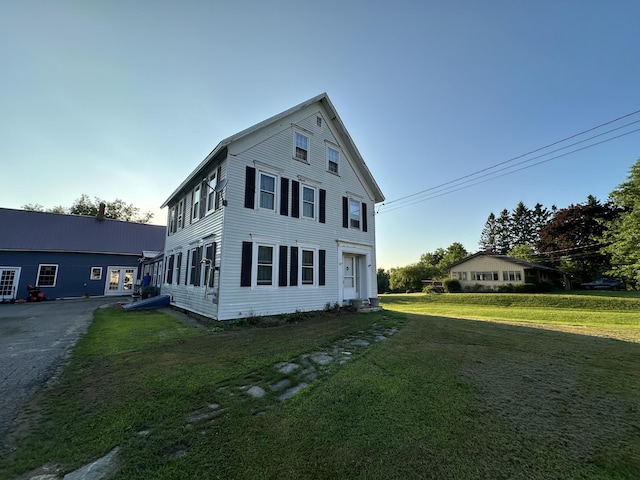 view of property exterior with a yard