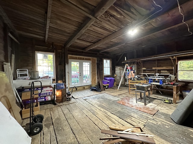 miscellaneous room featuring french doors, wood-type flooring, and wooden walls