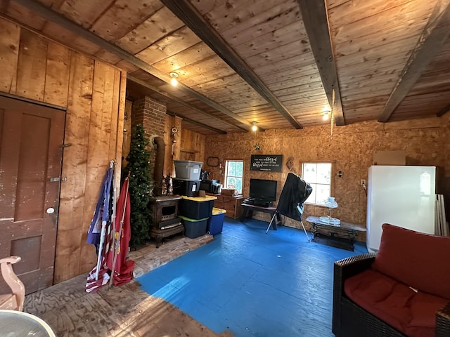 interior space featuring beamed ceiling and wooden walls