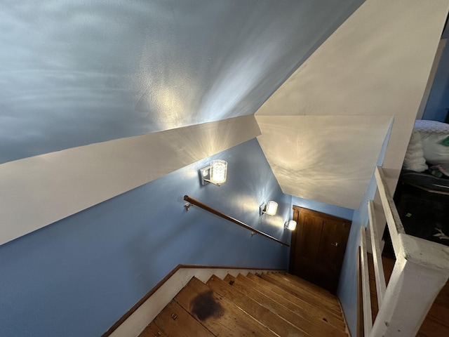 stairway with vaulted ceiling