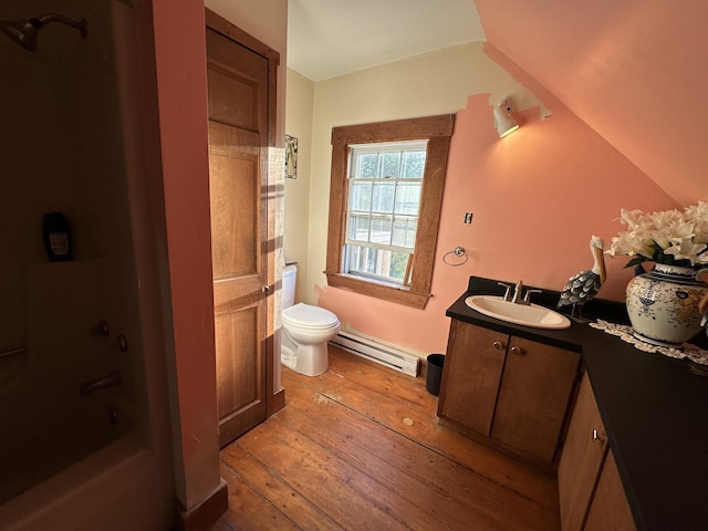 bathroom featuring a baseboard radiator, hardwood / wood-style floors, vanity, and toilet