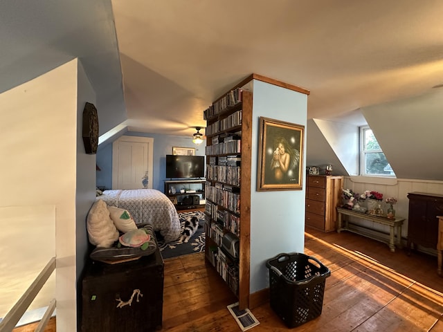 bedroom featuring lofted ceiling and dark hardwood / wood-style flooring