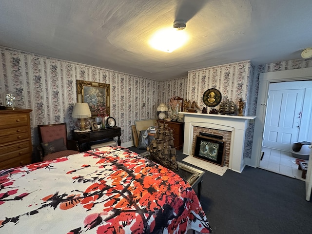 bedroom with carpet and a fireplace