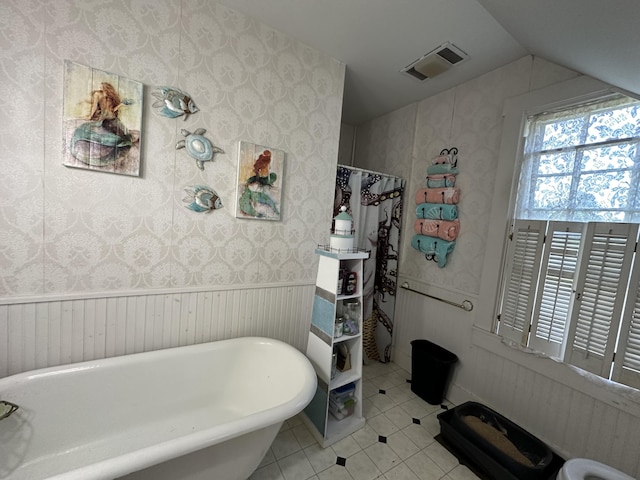 bathroom featuring tile patterned floors and a bathtub