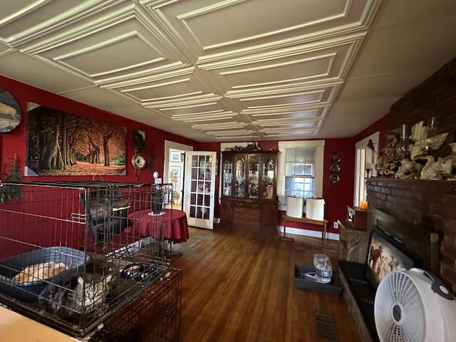 living room with hardwood / wood-style flooring and a tiled fireplace