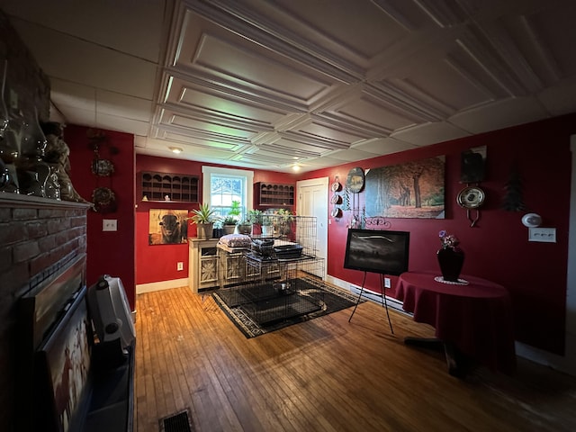 living room with coffered ceiling and wood-type flooring