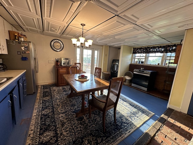 dining room featuring an inviting chandelier, washer / clothes dryer, plenty of natural light, and sink