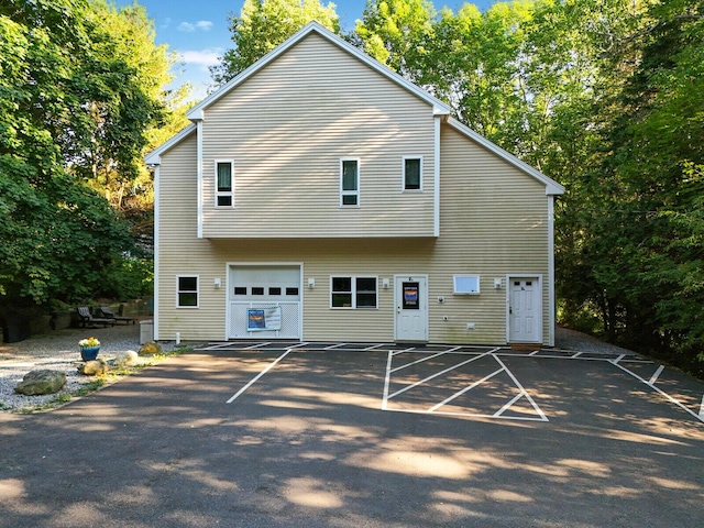 back of property featuring a garage