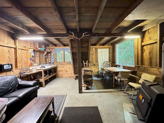 basement featuring wooden ceiling, wooden walls, and a workshop area