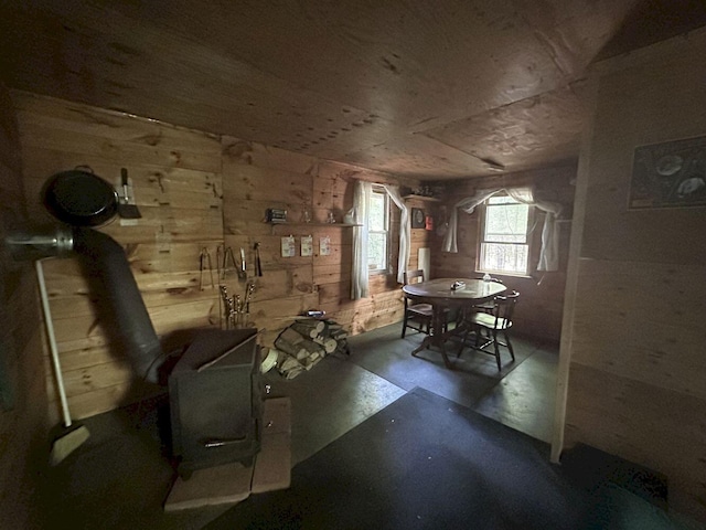 misc room featuring concrete floors and wooden walls