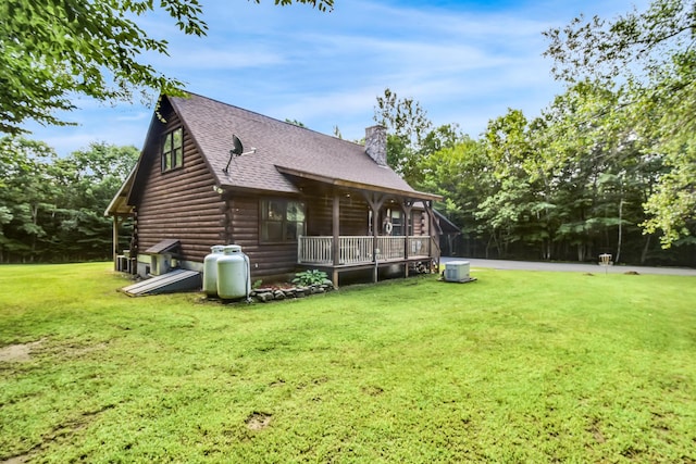 back of house with a yard and covered porch