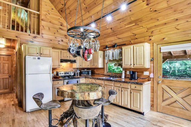kitchen featuring stainless steel appliances, sink, light brown cabinets, high vaulted ceiling, and light hardwood / wood-style floors