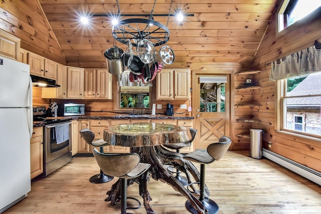 kitchen featuring light brown cabinetry, a baseboard radiator, white fridge, stainless steel electric range oven, and lofted ceiling