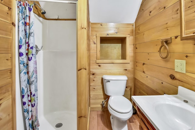 bathroom featuring a shower with shower curtain, vaulted ceiling, wooden walls, wood-type flooring, and toilet