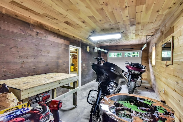 misc room featuring concrete flooring, wooden walls, and wooden ceiling