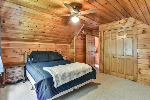 bedroom with carpet flooring, wood ceiling, ceiling fan, wooden walls, and a closet