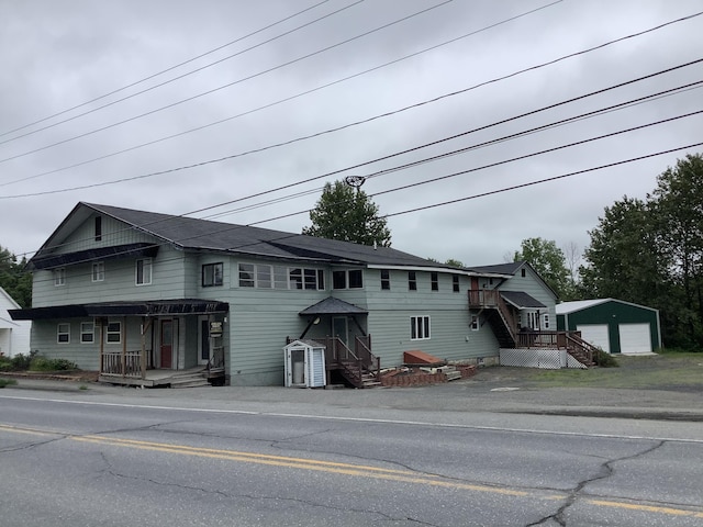 view of front facade featuring a garage and an outbuilding