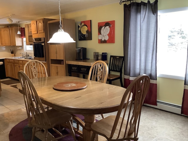 dining area with light tile patterned flooring and sink