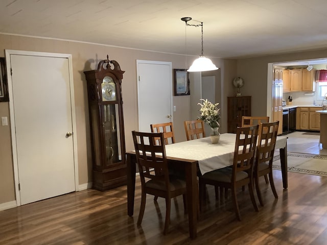 dining space with dark hardwood / wood-style floors and sink