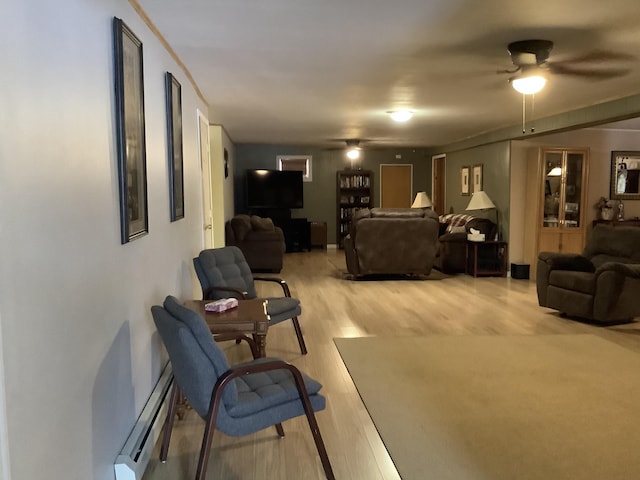 living room with ceiling fan, hardwood / wood-style flooring, and a baseboard radiator