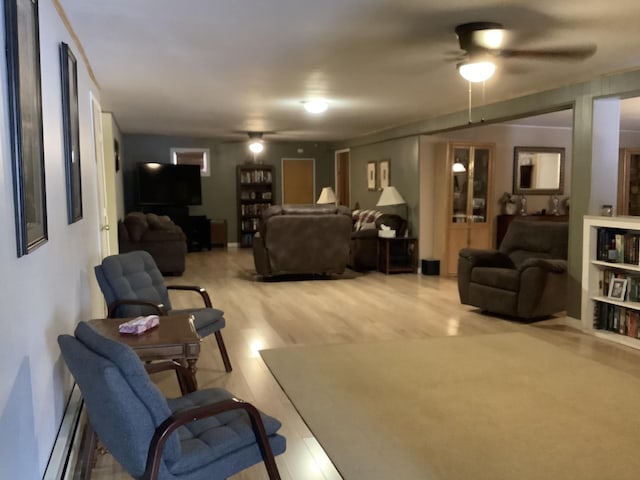 living room with ceiling fan, hardwood / wood-style floors, and a baseboard radiator