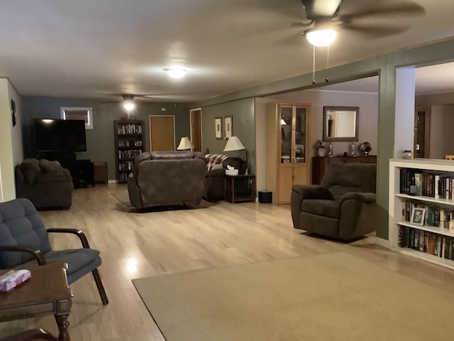 living room with ceiling fan and light hardwood / wood-style flooring