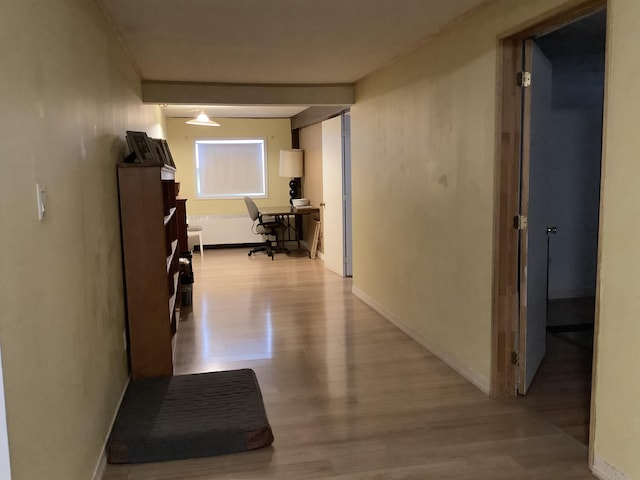 corridor with light hardwood / wood-style flooring