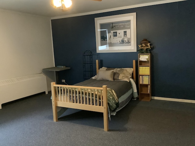 carpeted bedroom featuring ceiling fan, radiator, and ornamental molding