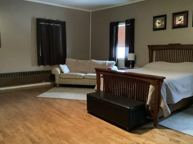 bedroom featuring radiator and hardwood / wood-style flooring