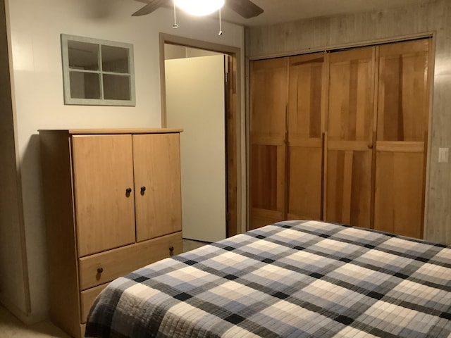 bedroom featuring ceiling fan and two closets