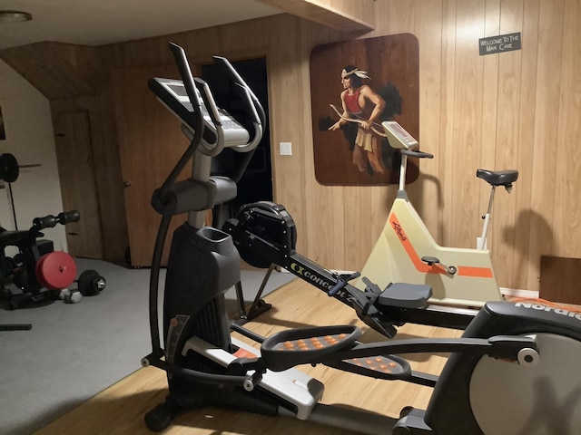 workout room featuring wood walls