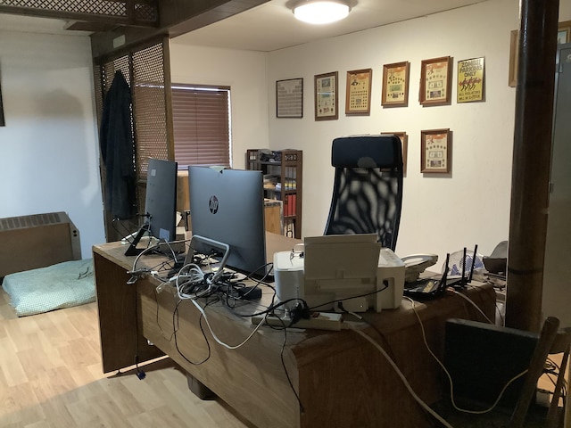 home office with light hardwood / wood-style floors