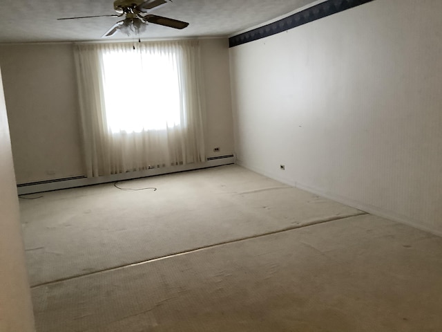 carpeted spare room featuring ceiling fan and a baseboard radiator