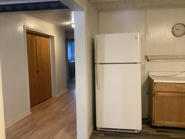 kitchen with white refrigerator and wood-type flooring