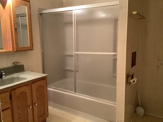 bathroom with vanity and shower / bath combination with glass door