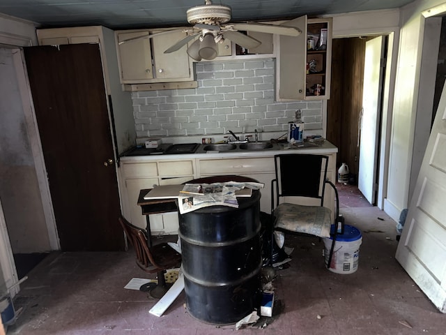 kitchen featuring ceiling fan, sink, and decorative backsplash