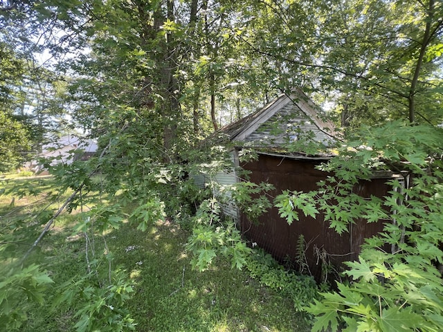 view of side of property with a shed