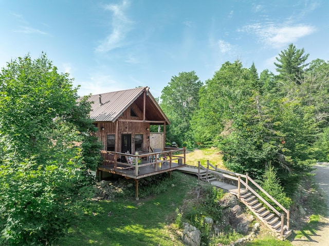 rear view of house featuring a deck