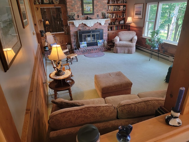 living room featuring carpet flooring, a brick fireplace, and a baseboard heating unit