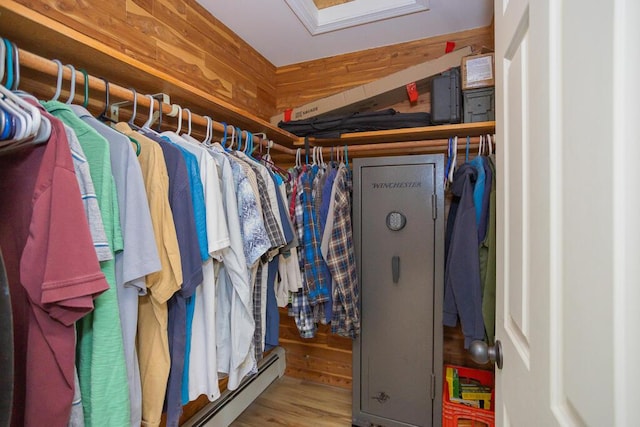 walk in closet with wood-type flooring