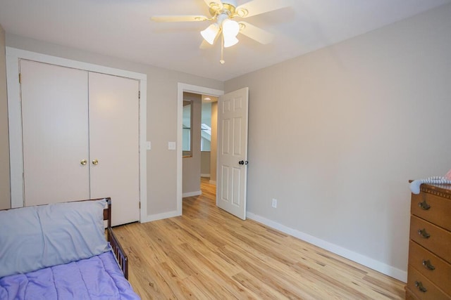 bedroom with ceiling fan, light hardwood / wood-style flooring, and a closet