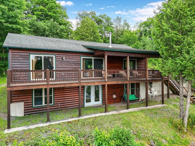 back of house with a deck and a yard