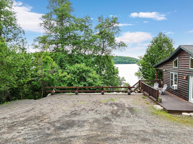 view of patio featuring a deck with water view