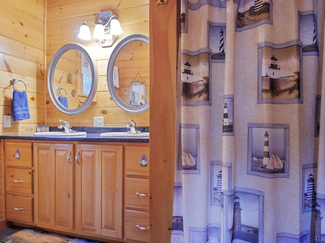 bathroom featuring vanity and wooden walls