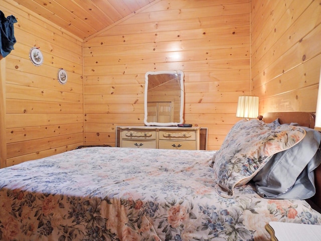 bedroom with wood walls, wooden ceiling, and vaulted ceiling